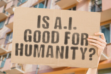 The question " Is A.I. good for humanity? " is on a banner in men's hands with blurred background. Company. Contract. Corporate. Intelligence. Justice. Standard. Businessman. Artificial