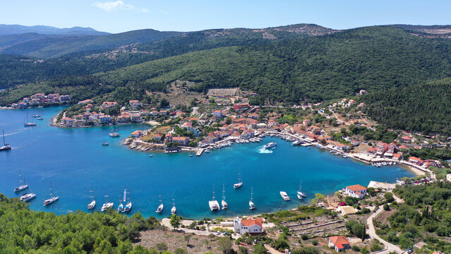 Aerial drone photo from iconic picturesque fishing village and bay of Fiskardo with beautiful traditional houses of Ionian architecture, Cefalonia island, Greece