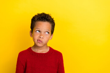Photo portrait of cute small schoolboy look disappointed copyspace dressed stylish red knitted garment isolated on yellow color background