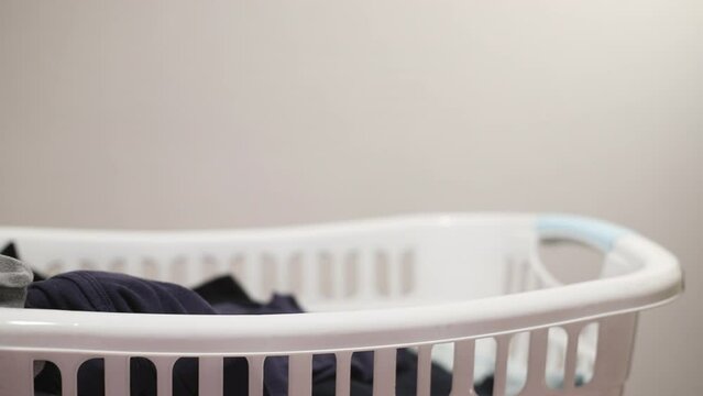 A man takes laundry to be ironed from the plastic basket
