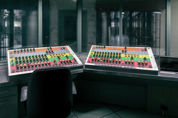 Penitentiary guard control room with two electrical panels with switches to open or close doors on...