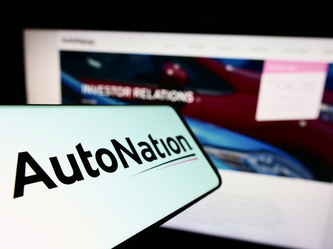 Stuttgart, Germany - 10-30-2022: Cellphone with logo of American automotive retail company AutoNation Inc. on screen in front of business website. Focus on left of phone display.