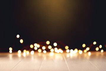 White wooden table with defocused bokeh lights.