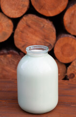 jar of milk at the wooden background