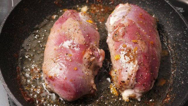 Cooking duck breast fillet on frying pan. Closeup