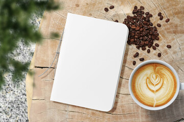 Clean minimal cover notepads mockup on wooden top with coffee beans and plant foreground