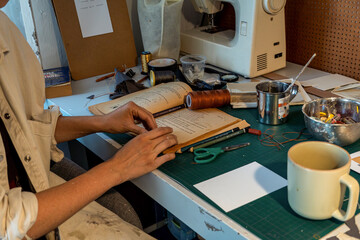 young latin woman, in her own painting studio, creates paintings different artistic techniques