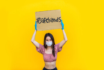 Young female portraits on colorful background with coronavirus face mask during pandemic flu -...