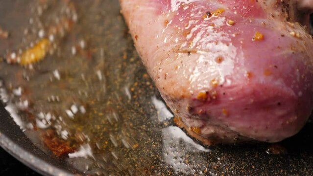 Cooking duck breast fillet on frying pan. Closeup