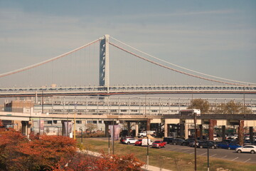 Large Urban Suspension Bridge with Parking Beneath it on Sunny Fall Day with Blue Sky