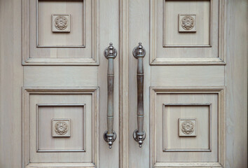 Old wooden door. The concept of minimalism and history. Details of classical architecture.