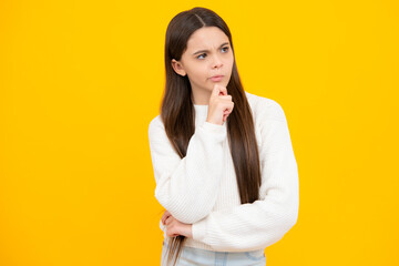 Thinking teenager girl, thoughtful emotion. Smart nerdy school girl touching cheek and thinking against yellow background. Child think and idea concept.