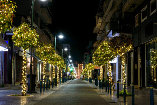 Promenade with trees decorated with Christmas lights.