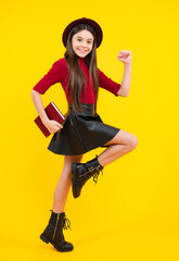 Naklejka premium Happy teenager portrait. Teenager school girl study with books. Learning knowledge and kids education concept. Smiling schoolgirl.