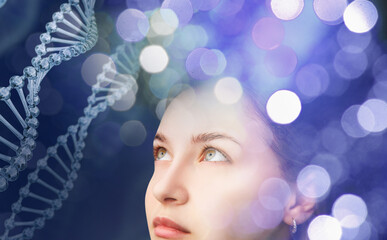 Young woman looks on the DNA stems.