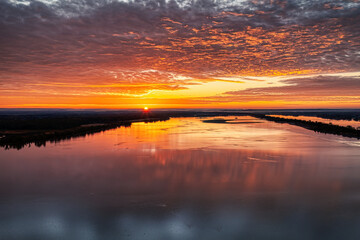 Sunrise over the Tennessee River with beautiful colorful orange sky. Wheeler Wildlife Refuge in Decatur Alabama USA.