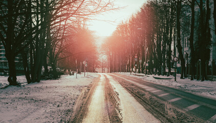 Empty city street in the winter time with soft sunlight