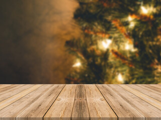 Empty wooden tabletop and blur room with a Christmas tree background, suitable for montage product