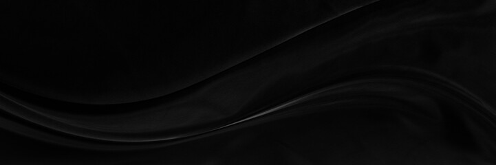 Black gray satin dark fabric texture luxurious shiny that is abstract silk cloth panorama background with patterns soft waves blur beautiful.