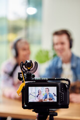 Couple With Dog Recording Podcast Or Broadcasting Interview On Radio In Studio At Home With Laptop