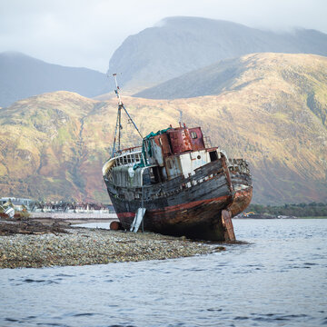 The Corpach Wreck.  A wrecked and abandoned trawler on the banks of Loch Eil, North West Scotland with Ben Nevis Mountain in the background.