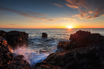  Rocky shore of the Atlantic Ocean at high tide at sunset