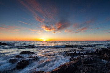  Rocky shore of the Atlantic Ocean at high tide at sunset
