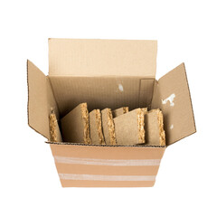 a pile of construction debris (plastic, MDF, aluminum, cardboard) in a brown cardboard box on a white background
