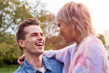 Loving Couple Outdoors In Countryside Laughing And Hugging