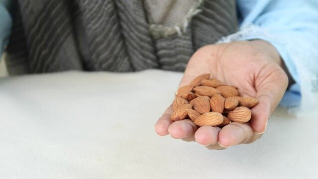women hand pick almond nut 