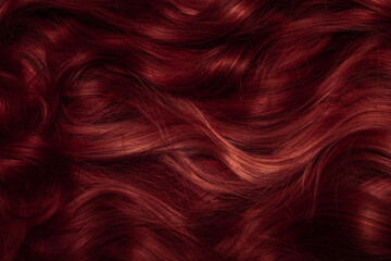 Dark red hair close-up as a background. Women's long brown hair. Beautifully styled wavy shiny...