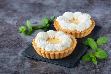Creamy cheesecake cake with mint on a gray table