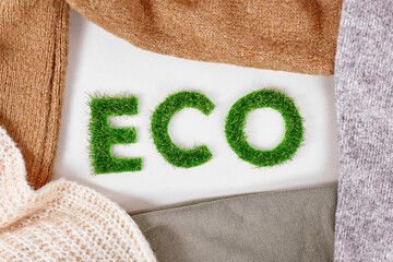 Concept for environmental friendly produced clothing with text 'ECO' made out of grass surrounded...