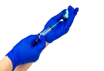 We draw out the injection liquid or vaccine with a syringe. Doctor's hands in blue gloves draw a...