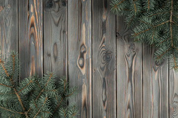 Christmas greeting card with fir tree decoration and empty wooden space in center. Christmas eve background, copy space