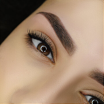 result correction and coloring of eyebrows with henna, close-up of the eye with coloring of eyebrows with henna
