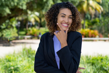 Laughing latin american businesswoman with blue blazer