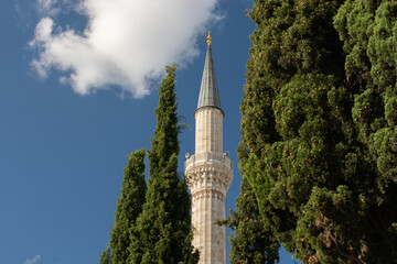 Minaret of a mosque in view. Silhouettes of Mosque