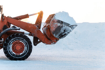 Bulldozer bucket with snow. Bulldozer removes snow with a bucket after a blizzard. Cleaning...