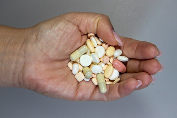 Many medicine pills in one palm