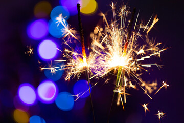 Burning sparklers. A close-up photo of New Year's fireworks with a blurred background