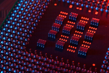 Computer cpu processor chip on circuit board ,motherboard background. Close-up. With red-blue lighting