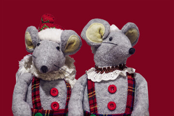 Mr and Mrs Christmas Mouse in plaid holiday outfits isolated on red