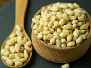 pine nuts on black stone background with copy space