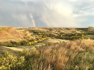Badlands landscape with rainbow