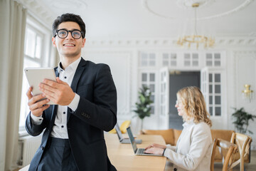 Marketing people a man and a woman work in an office together in business clothes.