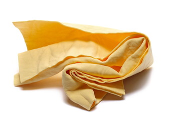 Yellow synthetic deerskin, chamois  for cleaning car windows isolated on white  - obrazy, fototapety, plakaty