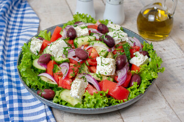 Greek salad. Salad with feta cheese and fresh vegetables. Isolated on white background. Top view	