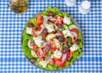 Greek salad with fresh vegetables, feta cheese and olive oil. Top view	