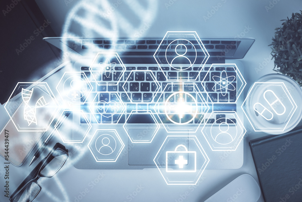 Poster dna hologram drawings over computer on the desktop background. top view. multi exposure. concept med